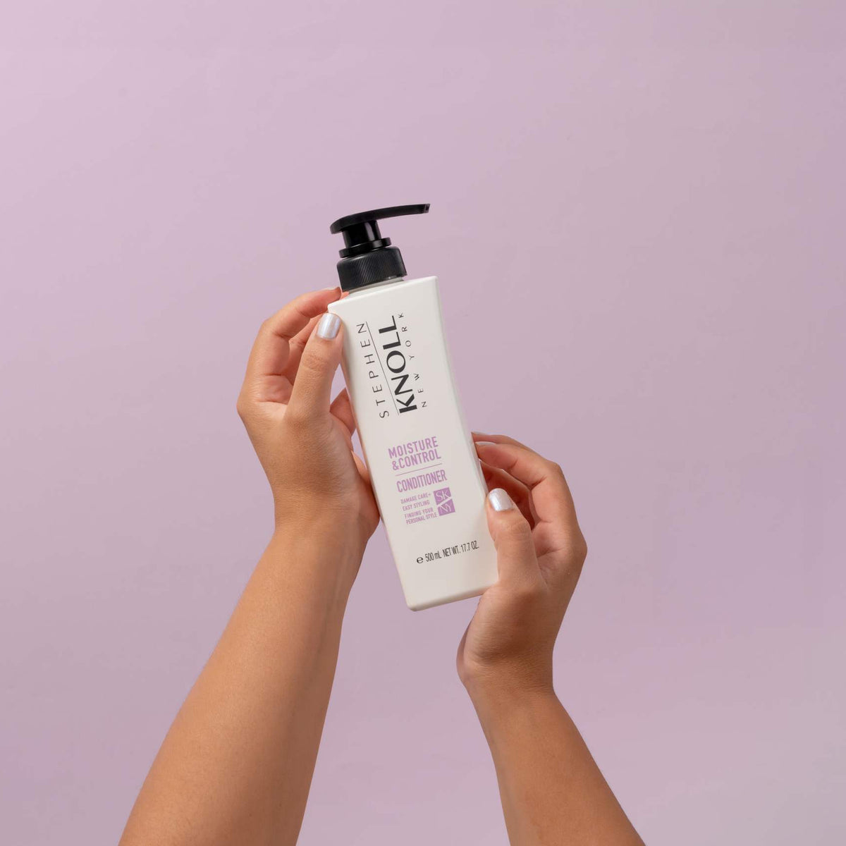 Stephen Knoll Moisture & Control Conditioner, 500 ml bottle, held in hand