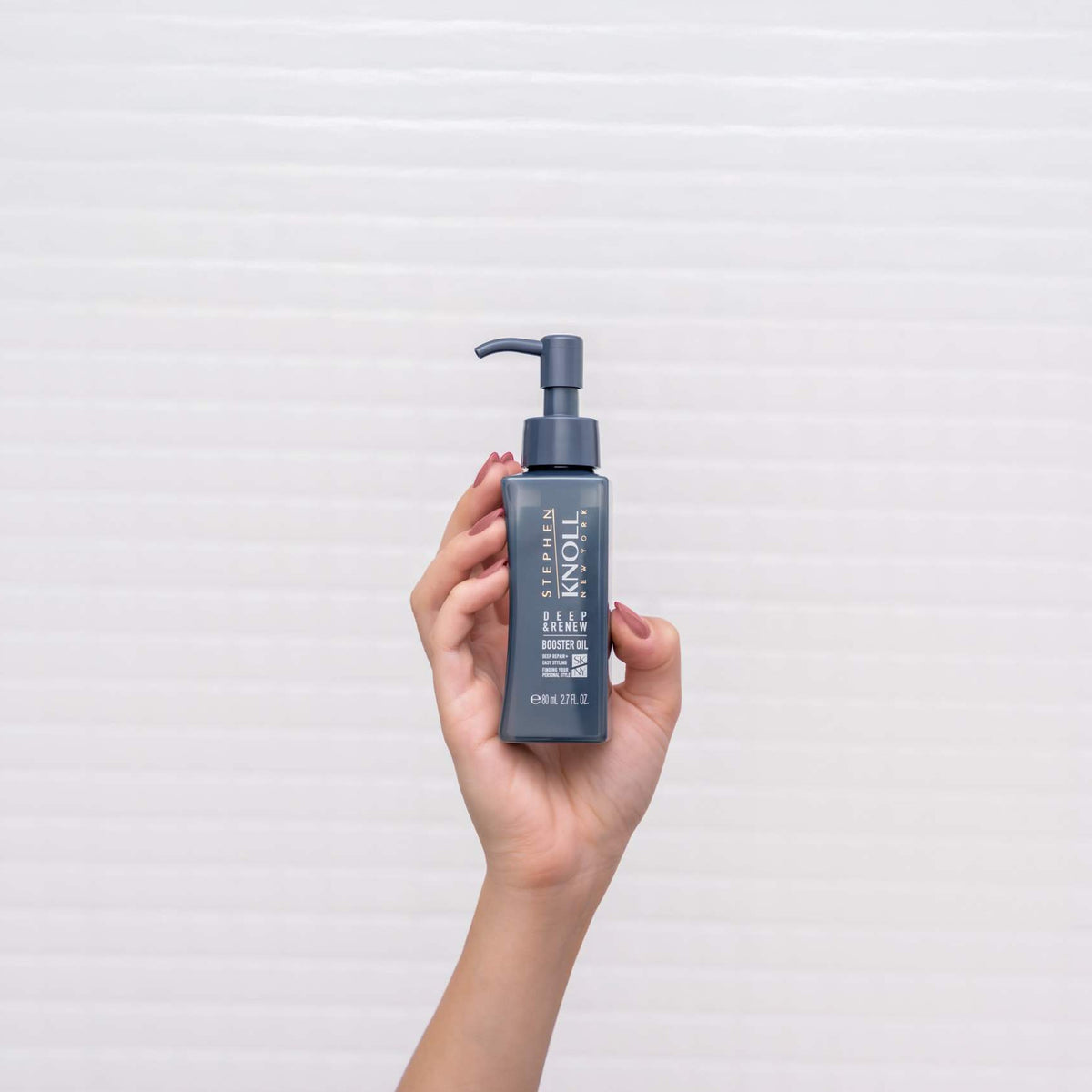 Stephen Knoll Deep & Renew Booster Oil bottle held in hand