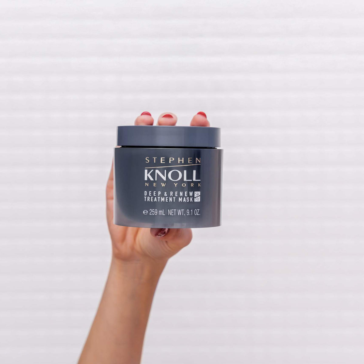 Stephen Knoll Deep & Renew Treatment Mask jar held in hand, front view